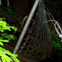 Rock-containing barriers protecting against mudslides and debris flows.