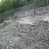 Laying rock-containing nets and barriers and rock stabilisation.