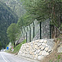 Rock-containing structures with HEA profiles on a concrete-reinforced, stone block wall.